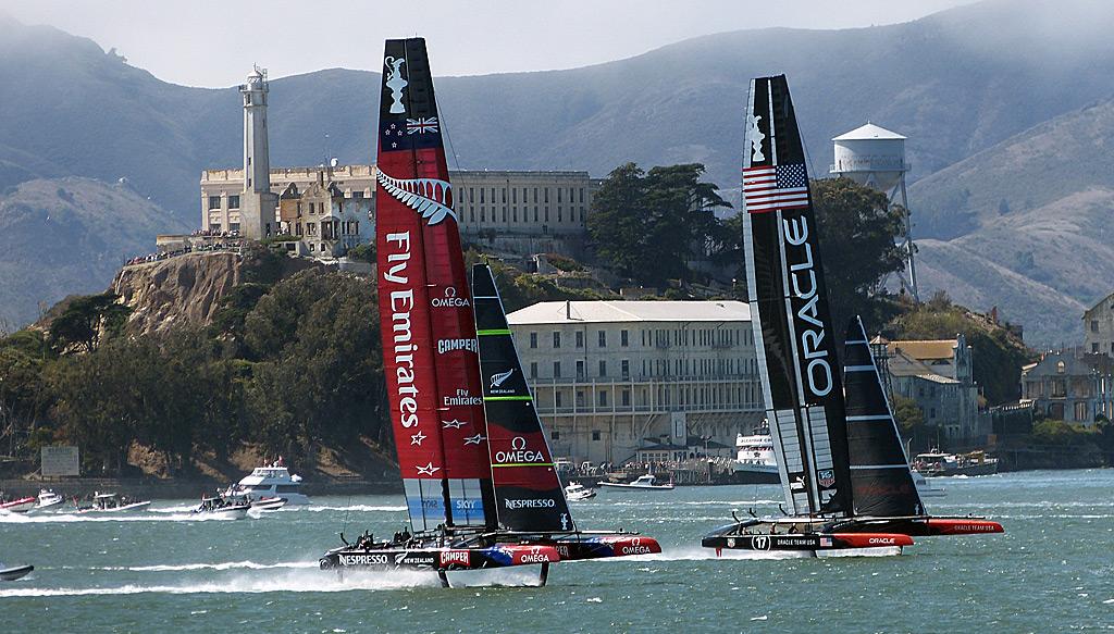 Oracle and Emirates Team New Zealand race past Alcatraz Island.